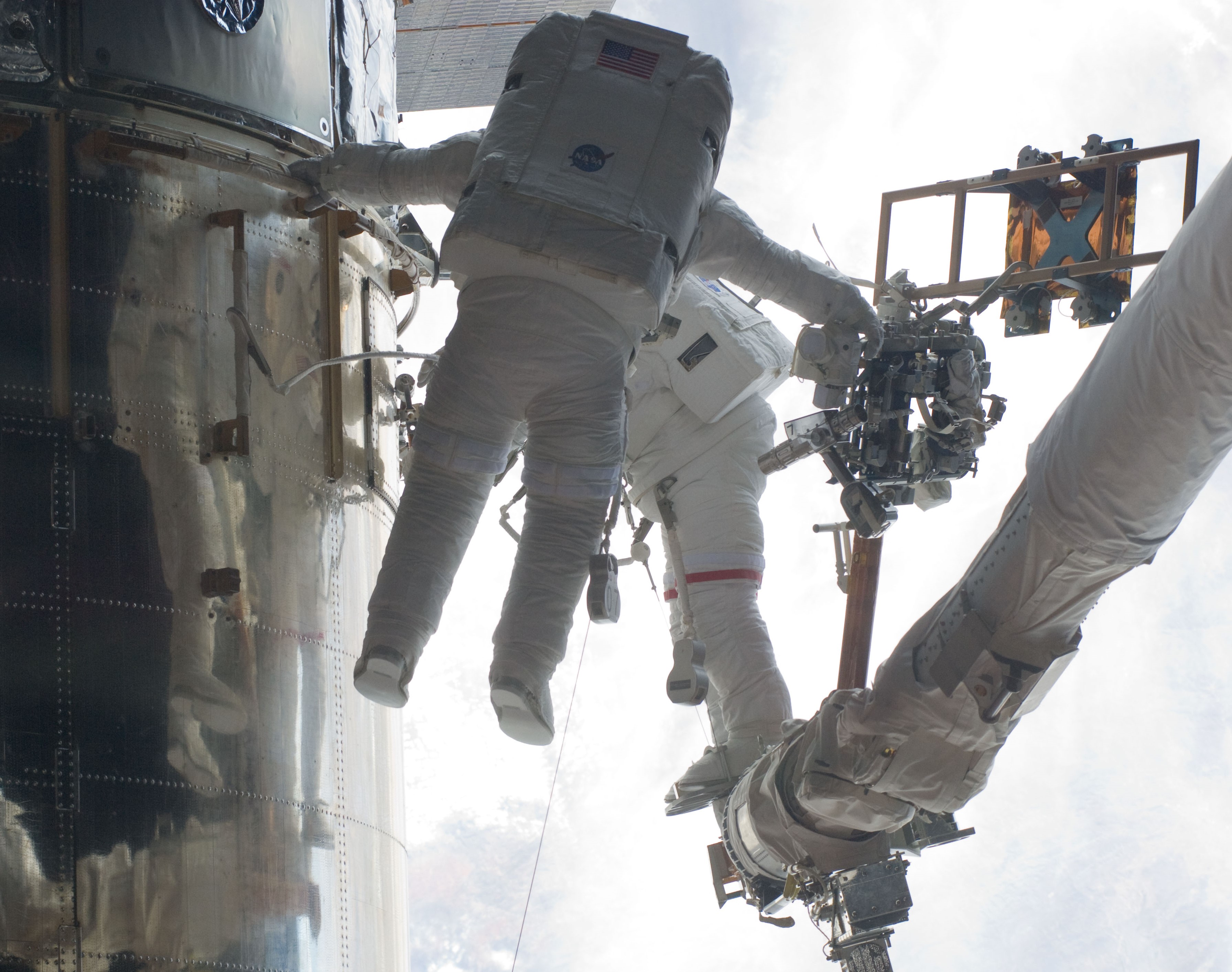 Andrew J. Feustel, left, and John M. Grunsfeld replace a Fine Guidance Sensor