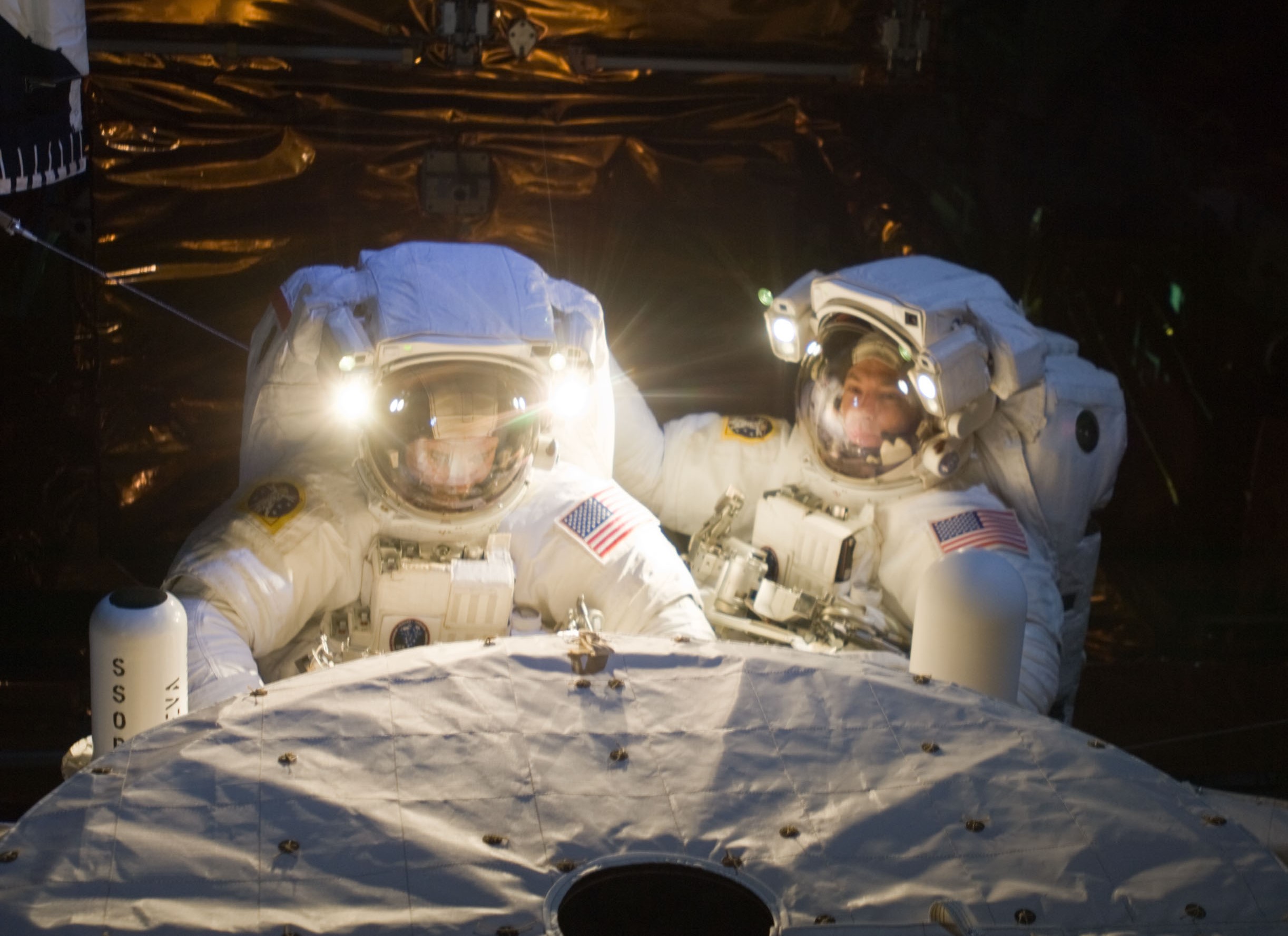 Grunsfeld, left, and Feustel prepare to enter the airlock to conclude the final Hubble servicing spacewalk