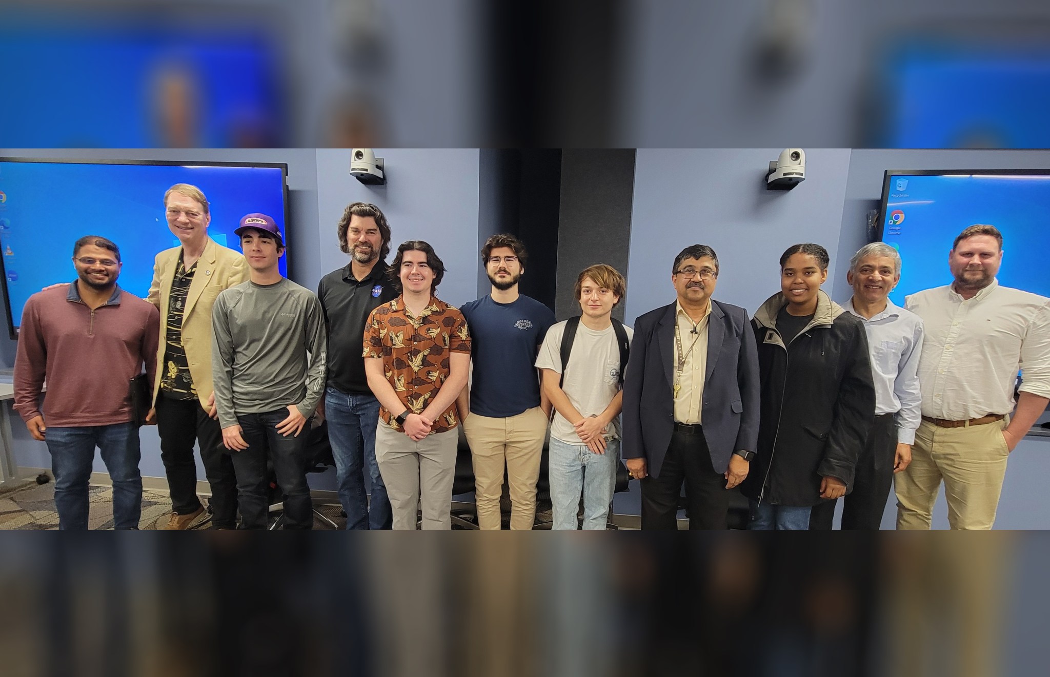 Eleven people stand side-by-side posing for a group picture. They represent participants of NASA's University Leadership Initiative (ULI).