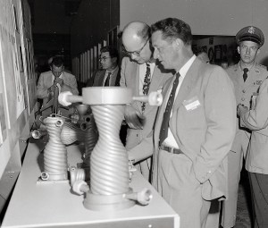 Men looking at small nozzles.