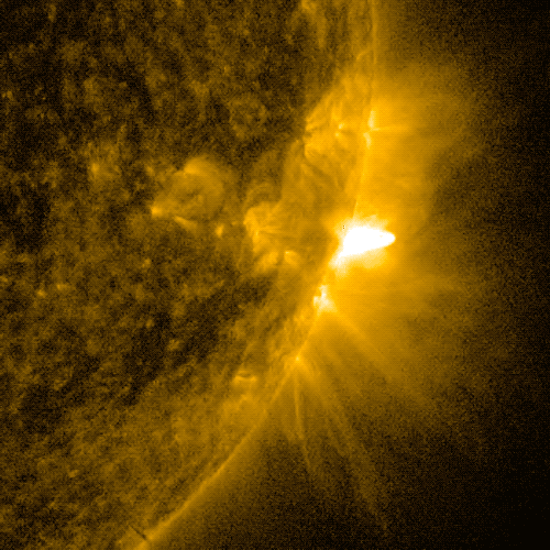 A solar flare erupting from the right edge of the Sun
