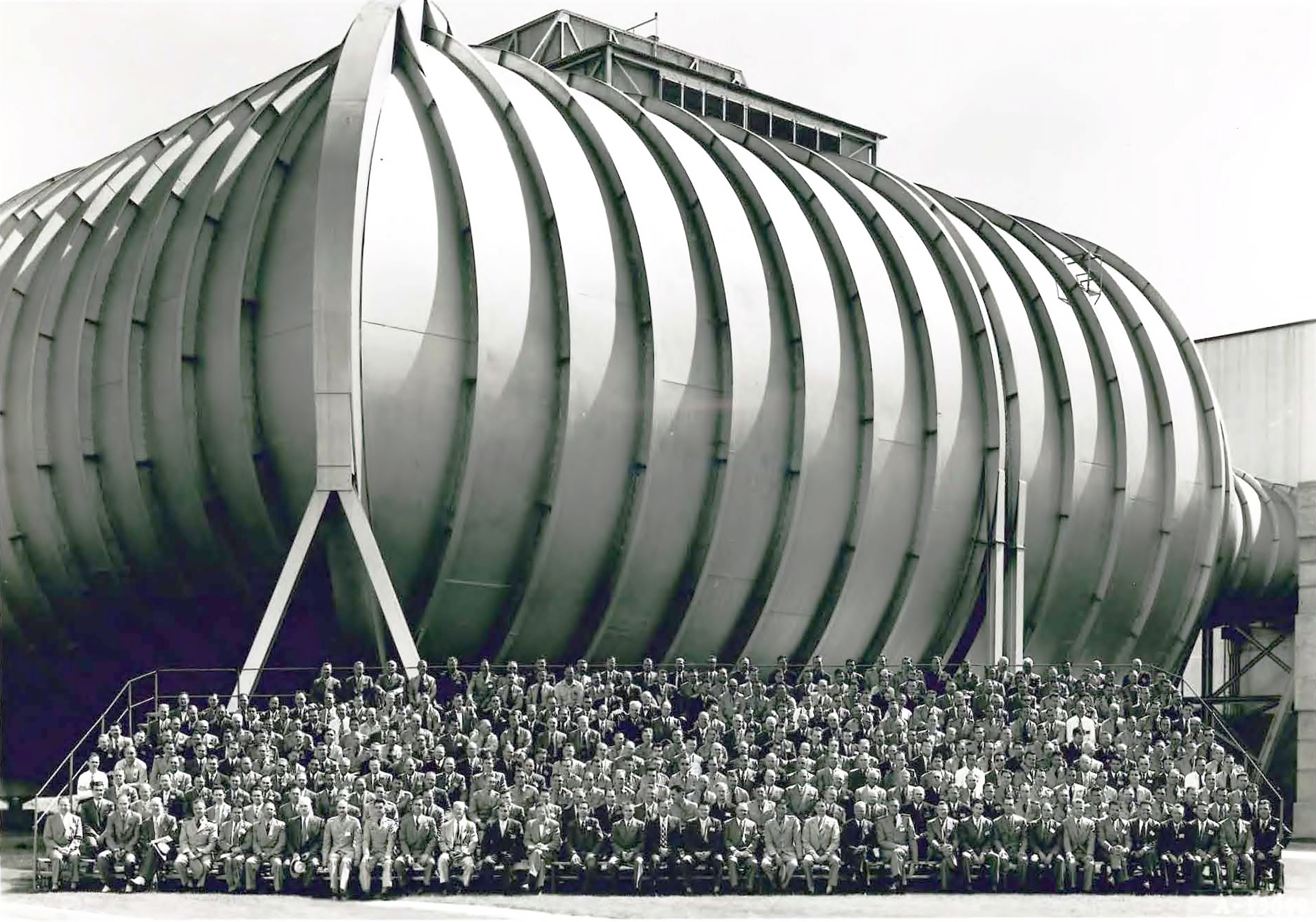 Group seated in front of wind tunnel.