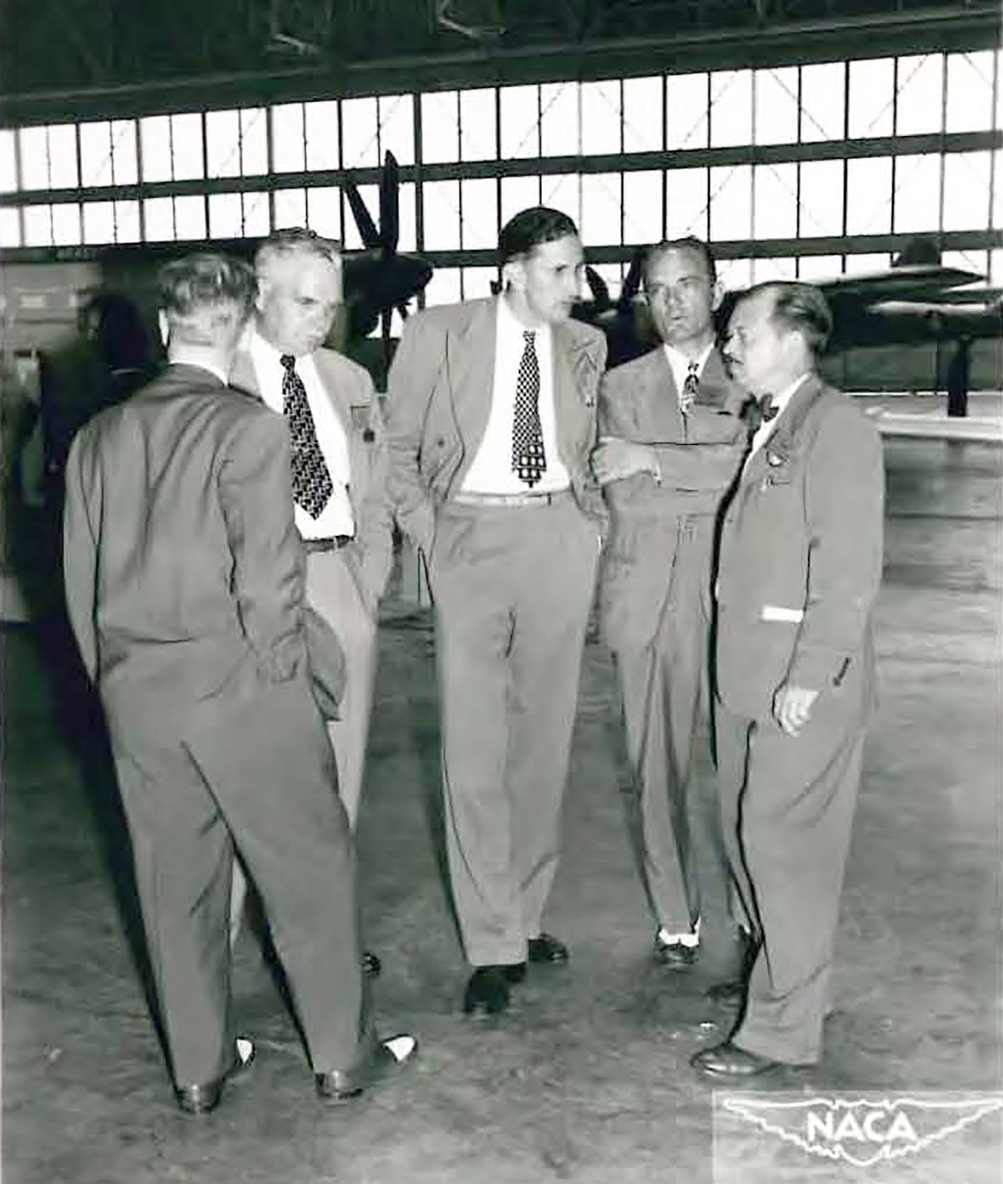 Five men talking.
