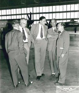 Five men talking.