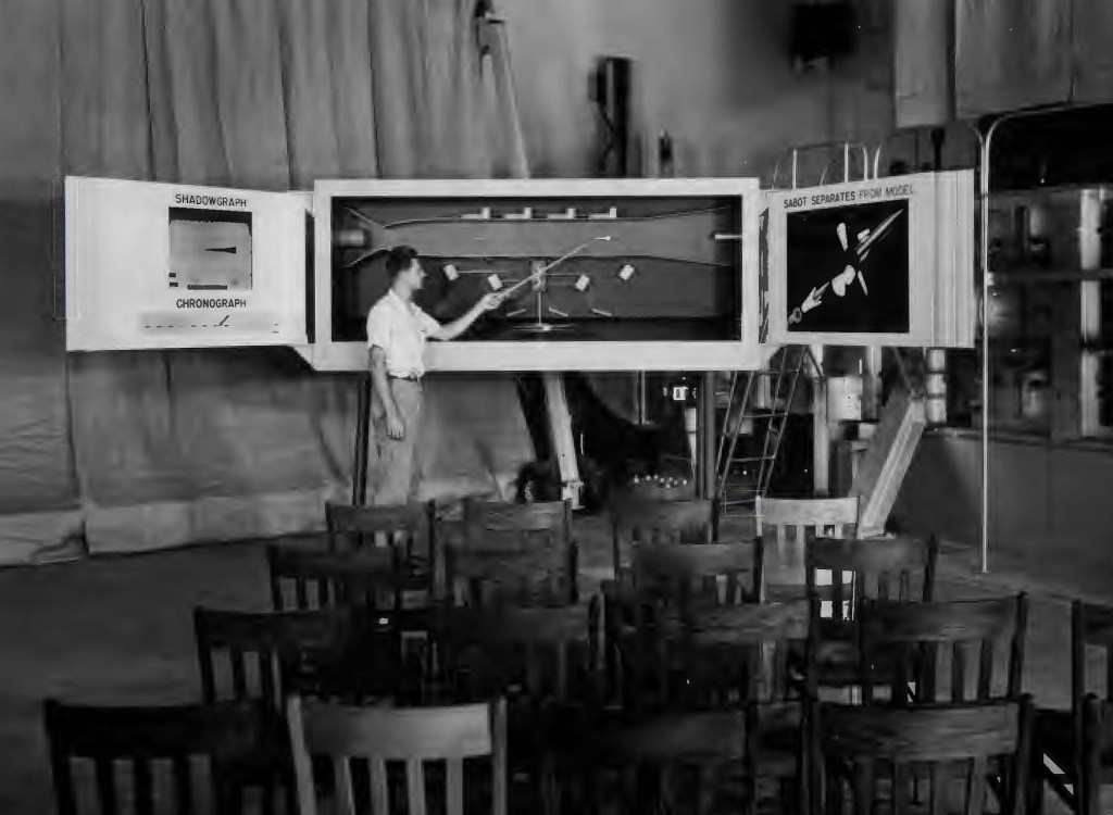 Man pointing to display.