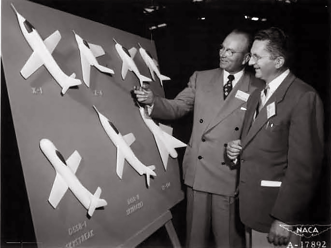 Two men looking at display.