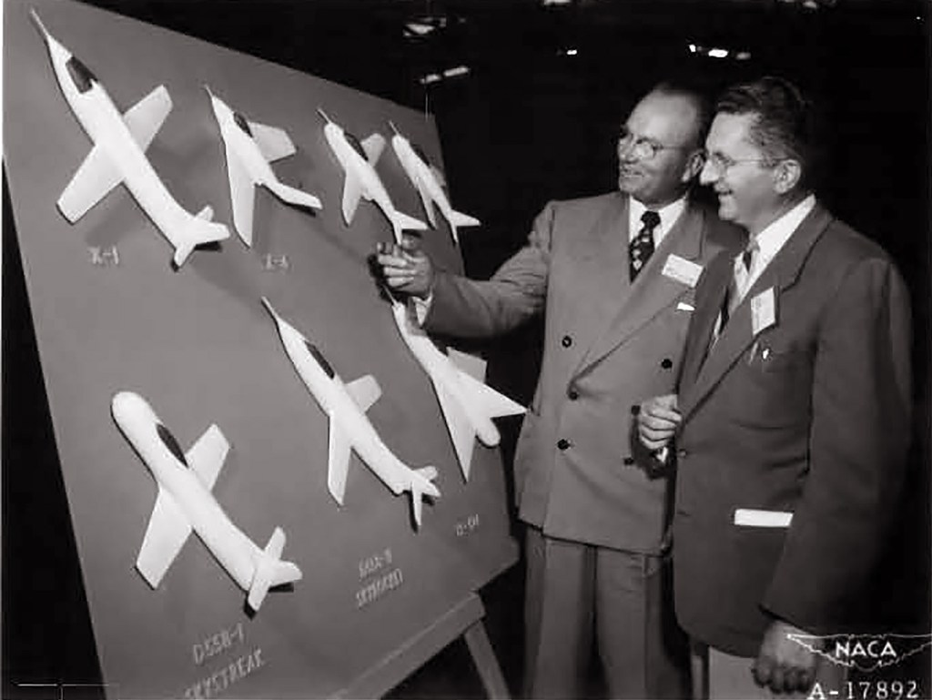 Two men looking at display.