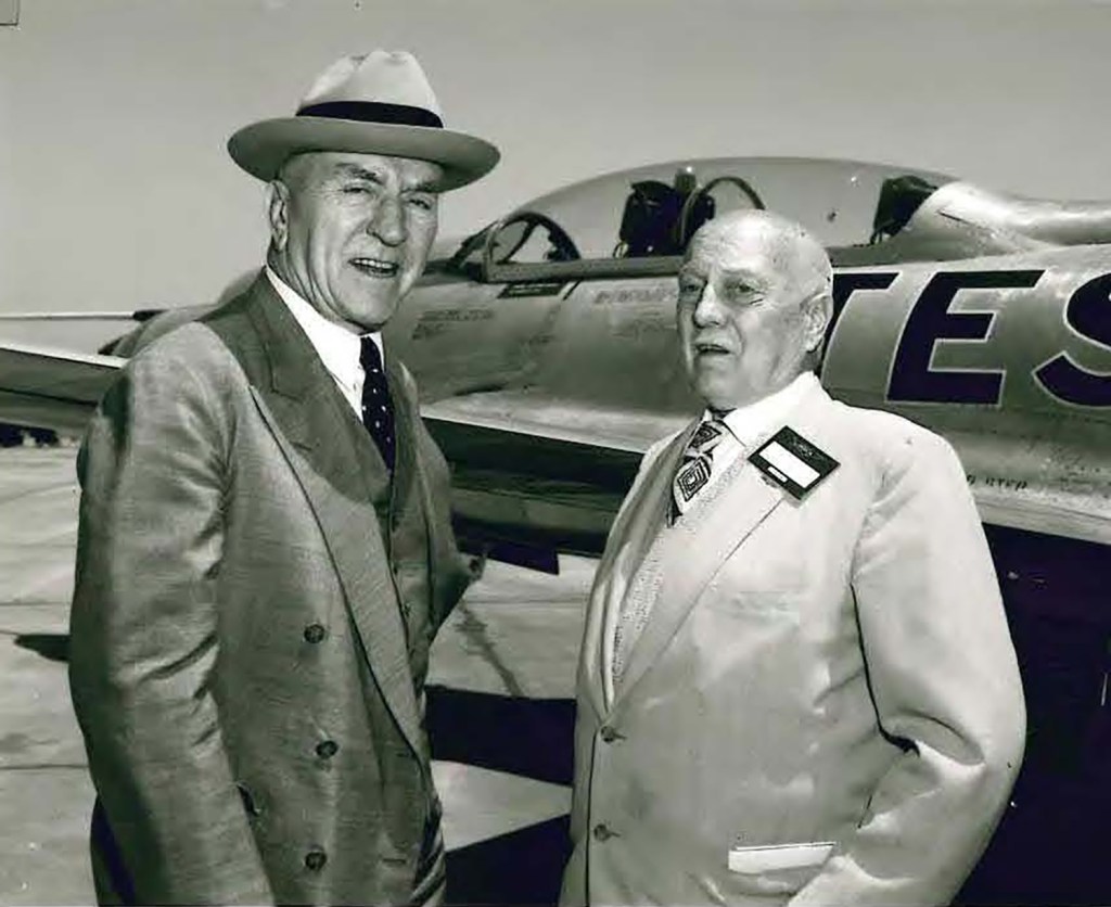 Two men outside airplane.