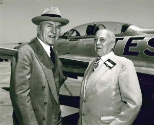 Two men outside airplane.