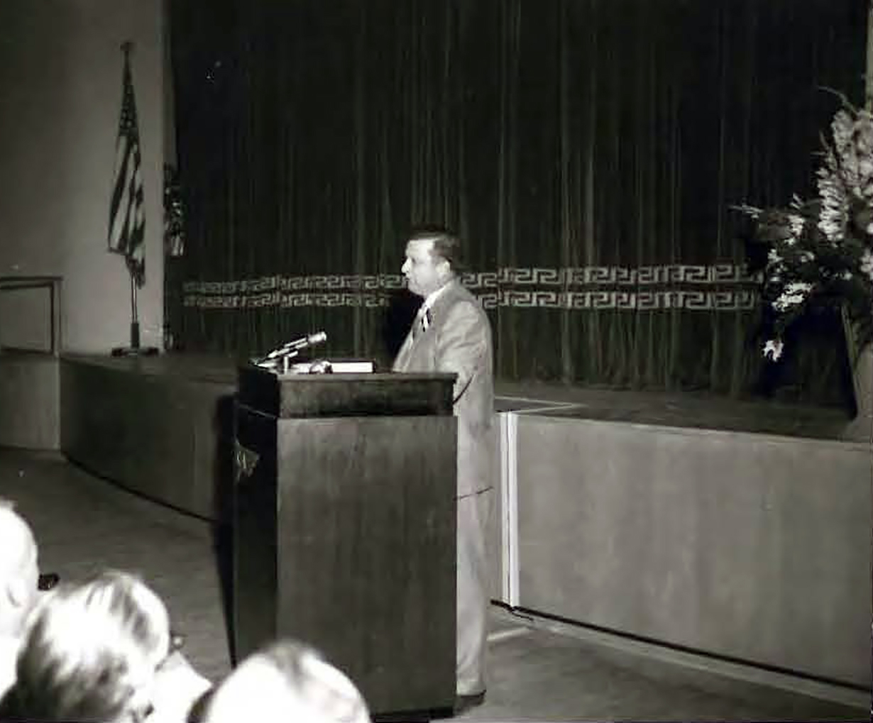 Man at podium.