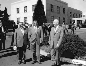 Men standing outside building.
