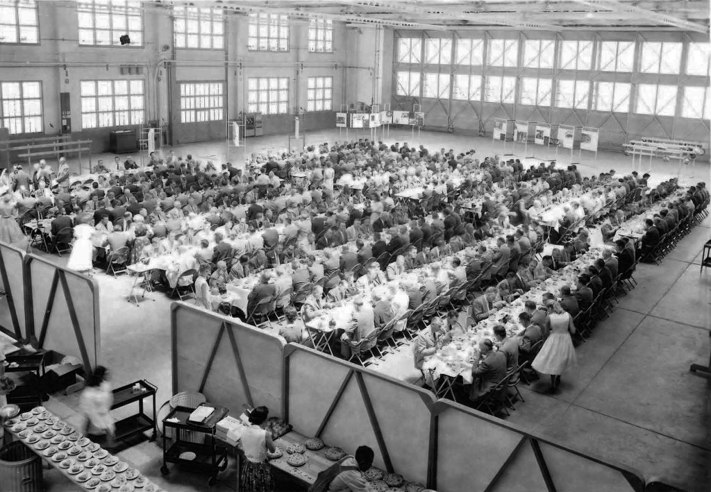 People seated at tables in shop.