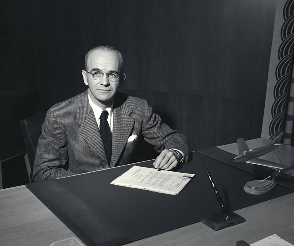 Man seated at desk.