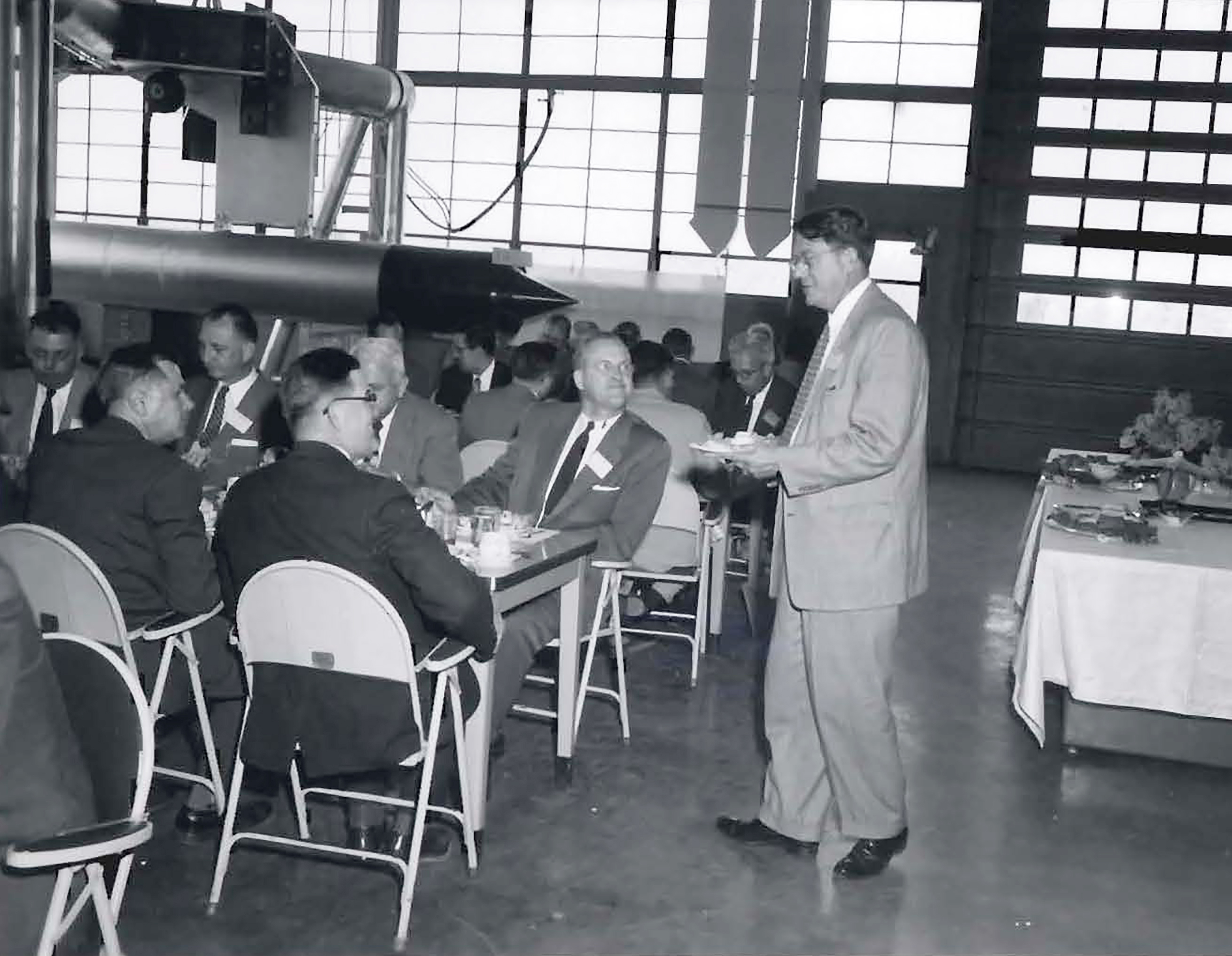 Group having lunnch in hangar.