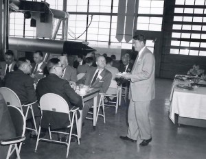 Group having lunnch in hangar.