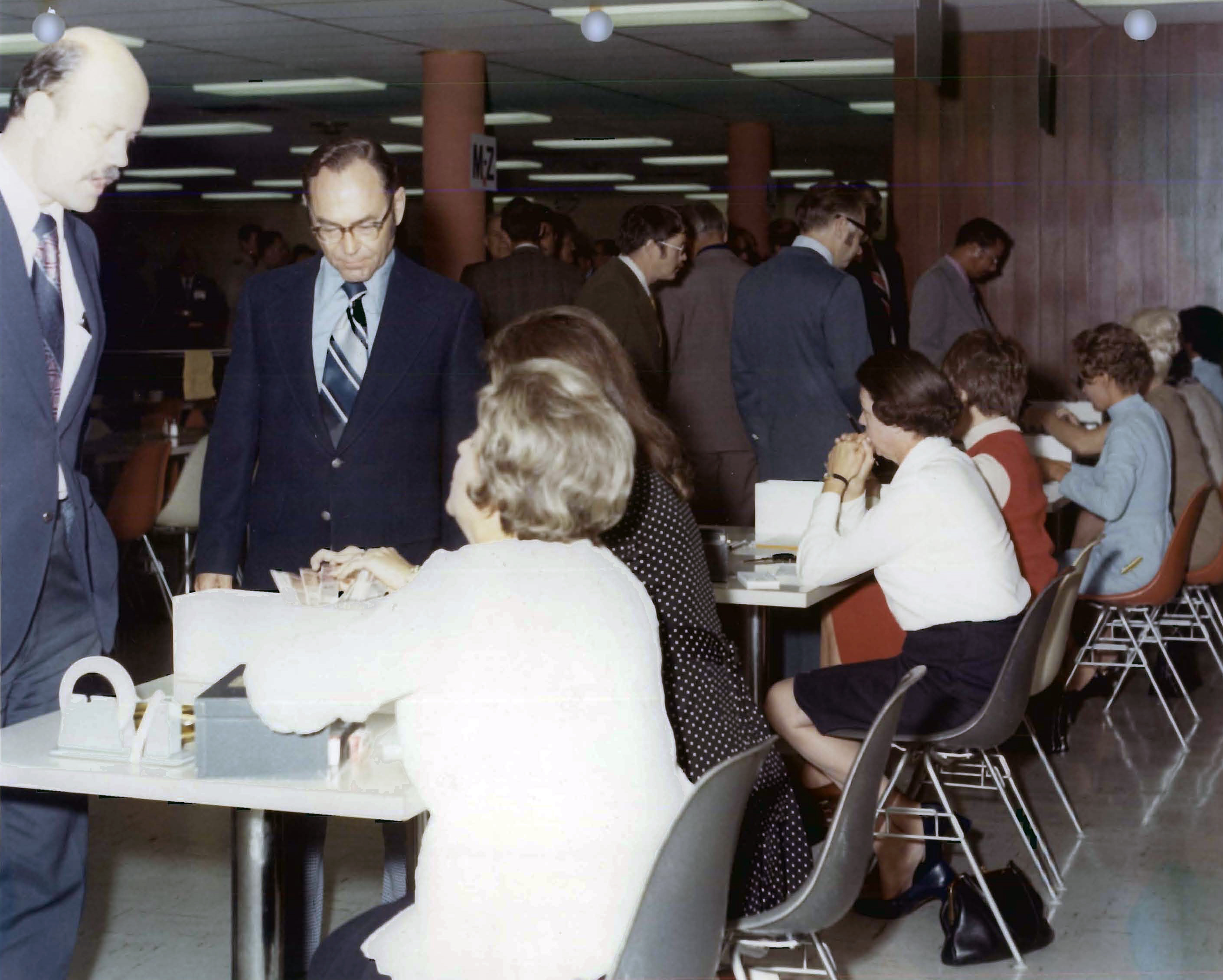 Seated women talking to standing men.