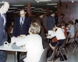 Seated women talking to standing men.