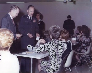 Seated women talking to standing men.