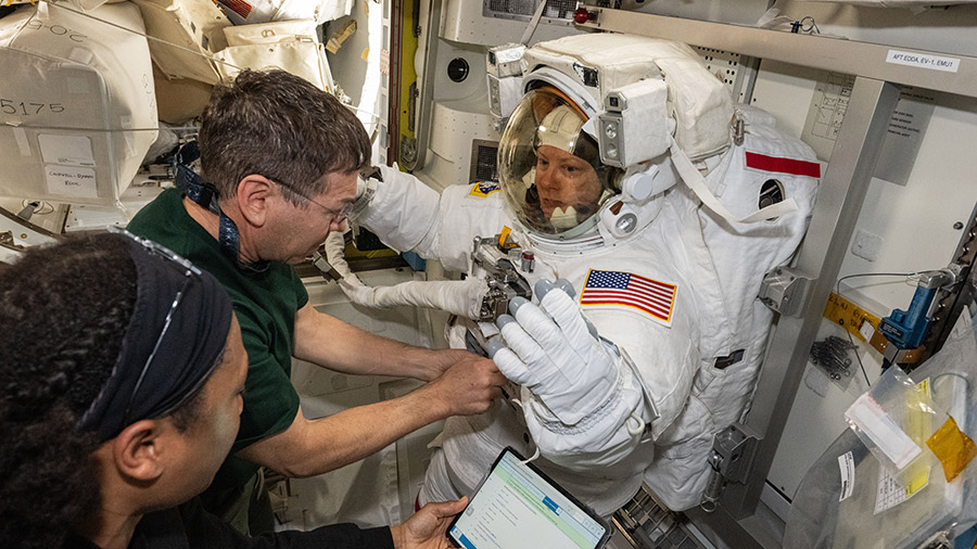 Atronauts (from left) Jeanette Epps and Mike Barratt assist astronaut Tracy C. Dyson during a spacesuit fit check on May 30.