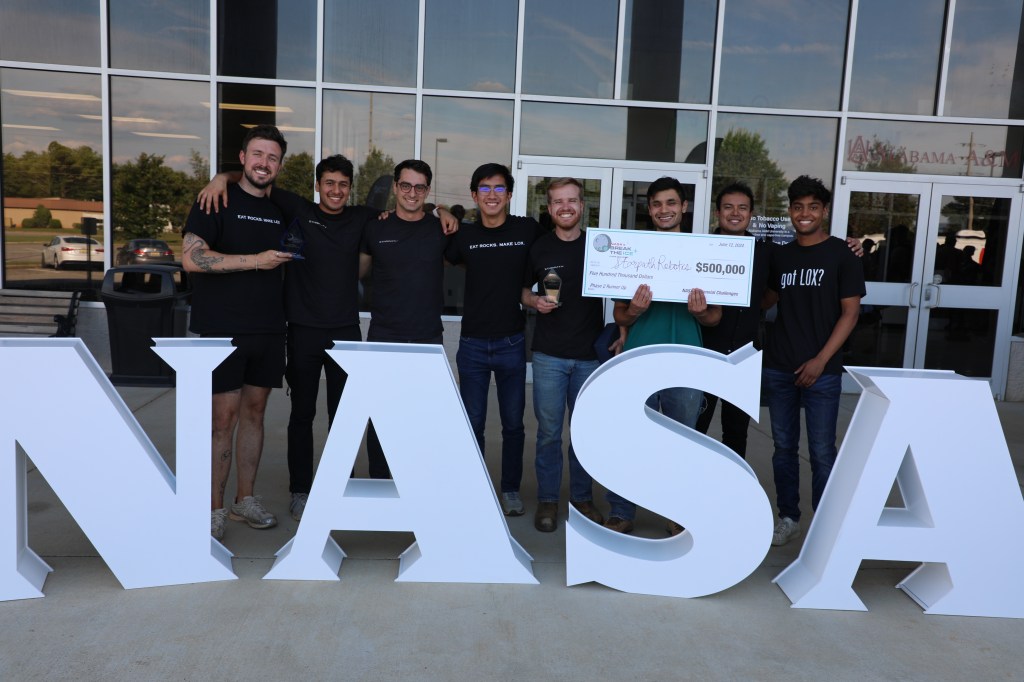 Starpath Robotics earned the second place prize for its four-wheeled rover that can mine, collect, and haul material during the final phase of NASA’s Break the Ice Lunar Challenge. From left, Matt Kruszynski, Saurav Shroff, Matt Khudari, Alan Hsu, David Aden, Mihir Gondhalekarl, Joshua Huang, and Aakash Ramachandran.