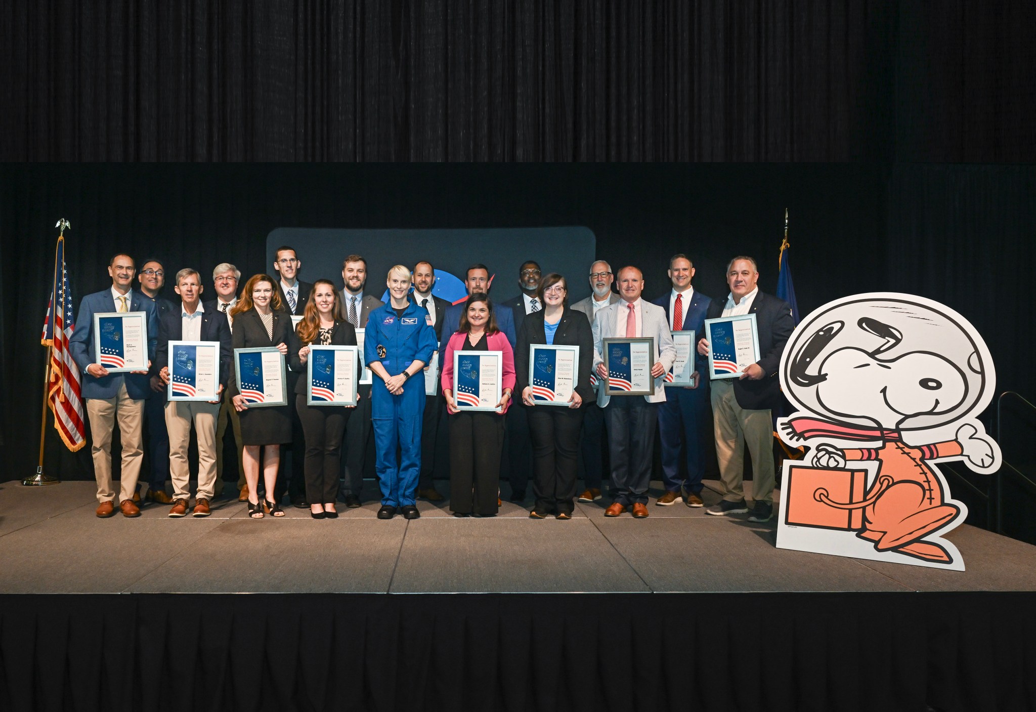 Recipients of the 2024 Silver Snoopy Awards at NASA’s Marshall Space Flight Center pose with their awards and NASA astronaut Kate Rubins, center, June 11 in Activities Building 4316. From left, front row, Mark Montgomery, Brian Saunders, Mignon Thame, Jessica Chaffin, Rubins, Stefanie Justice, Ellen Rabenberg, and Vince Vanek; back row, Manish Mehta, Bill Sadowski, Brad Addona, Christopher Buckley, Jonathan Burkholder, Joseph McCollister, Stacey Steele, Michael Fiske, Paul Gradl, and Trey Cate.