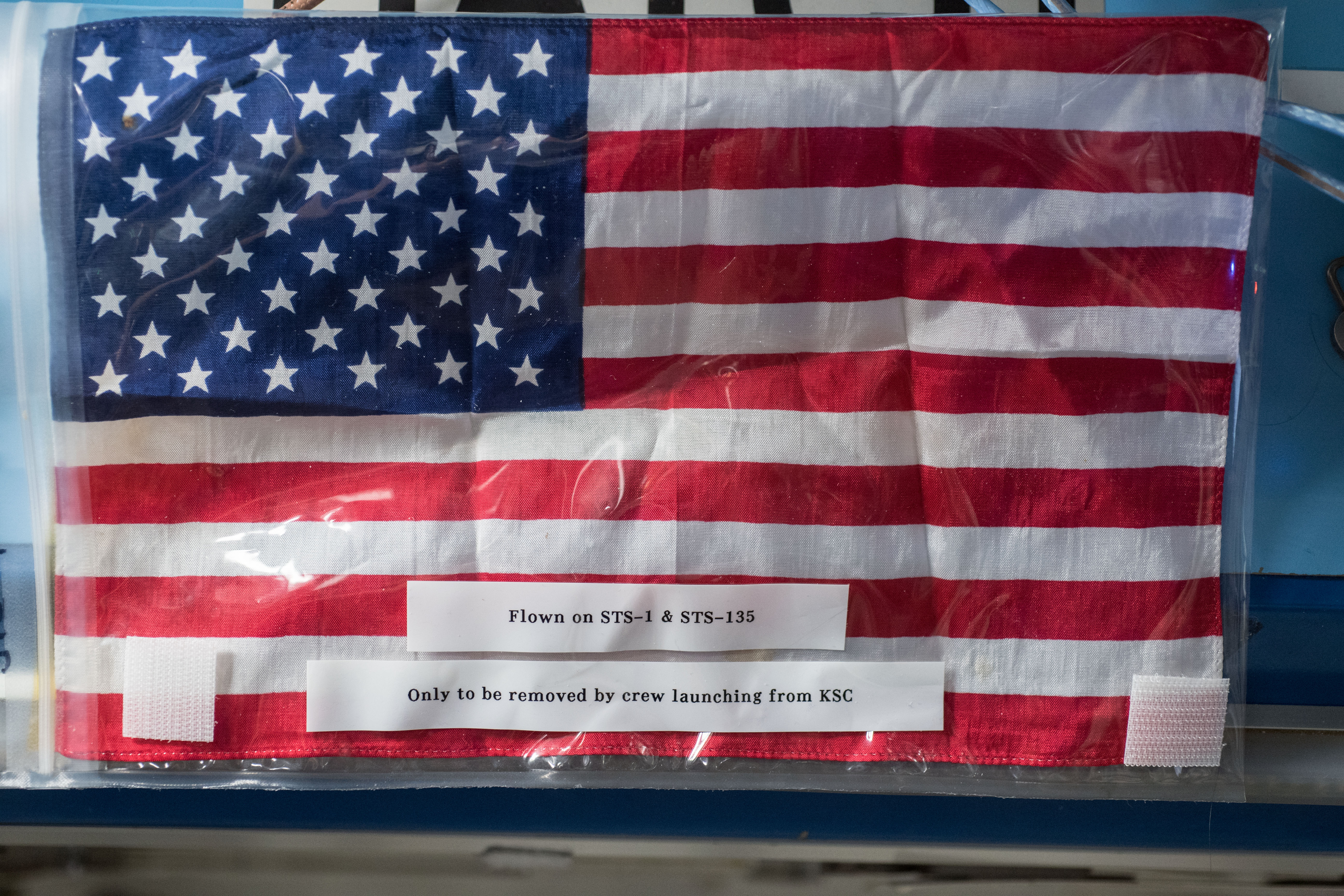 The Legacy Flag in July 2018 during Expedition 56, placed in a Ziploc bag for safety