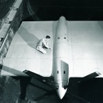 Man on wing span in wind tunnel.