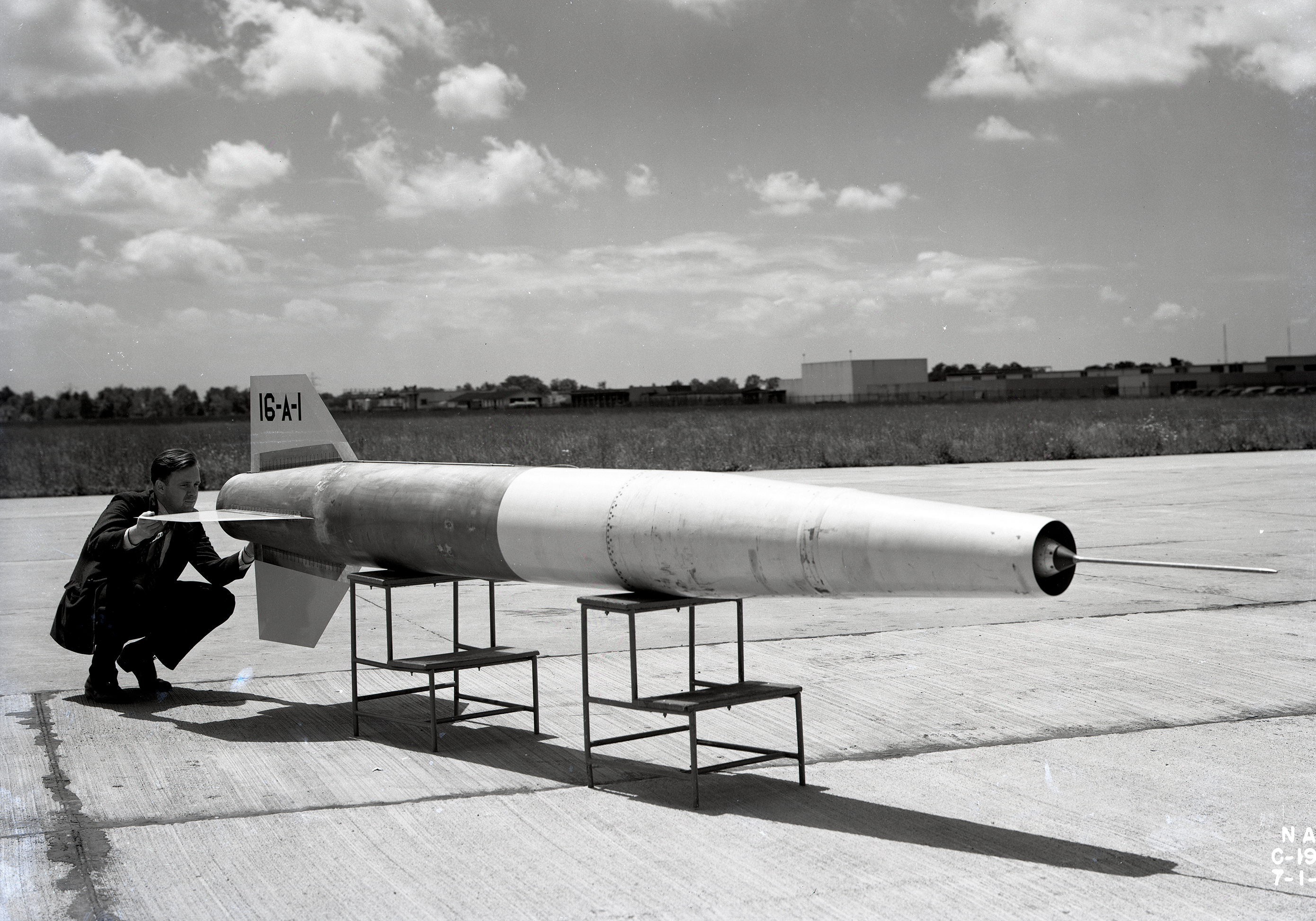 Man looking at small missile.