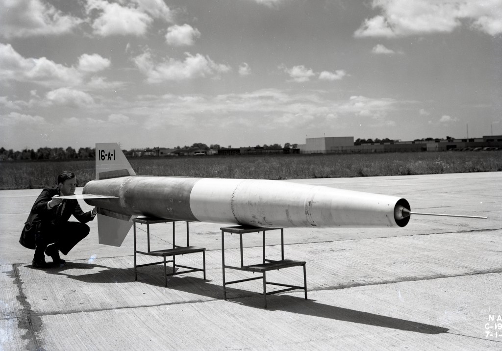 Man looking at small missile.
