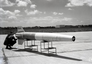 Man looking at small missile.