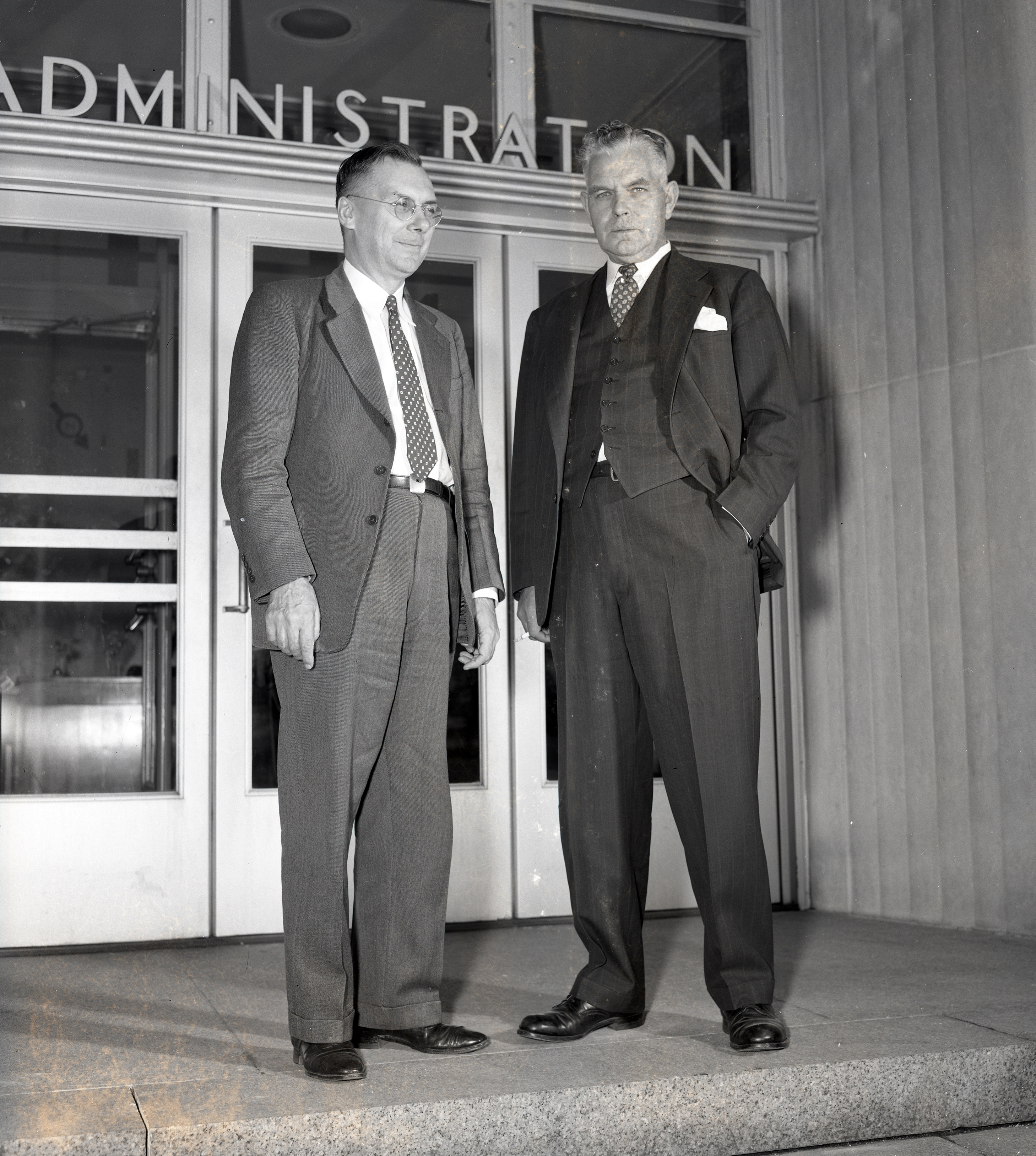 Two men standing outside doorwary