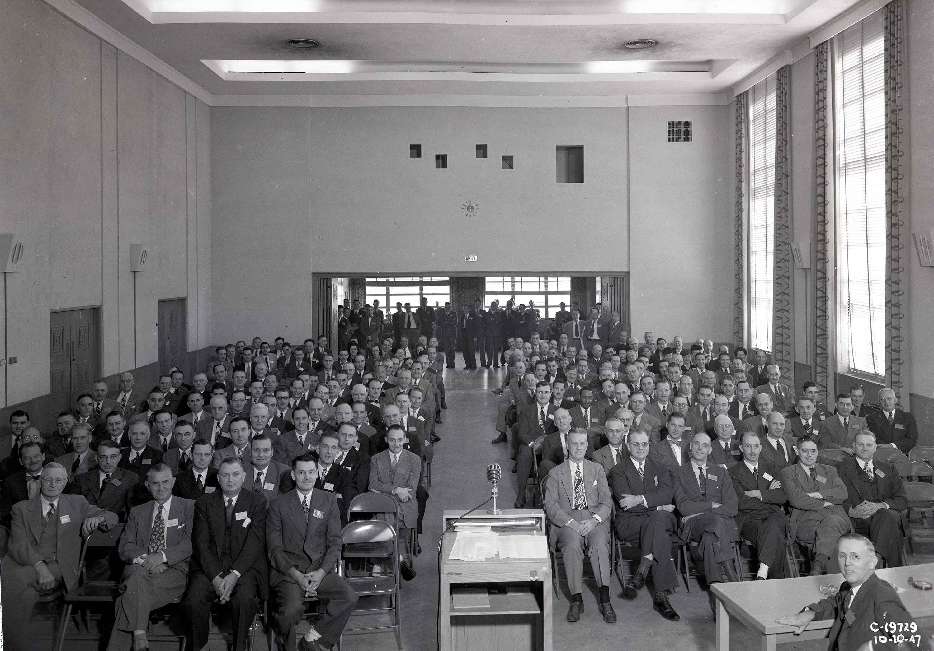 Group of people seated in auditorium.