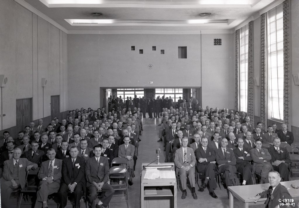 Group of people seated in auditorium.