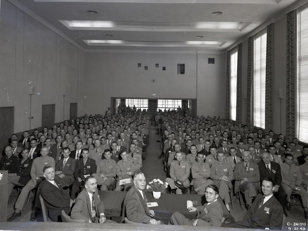 Group seated in auditorium.