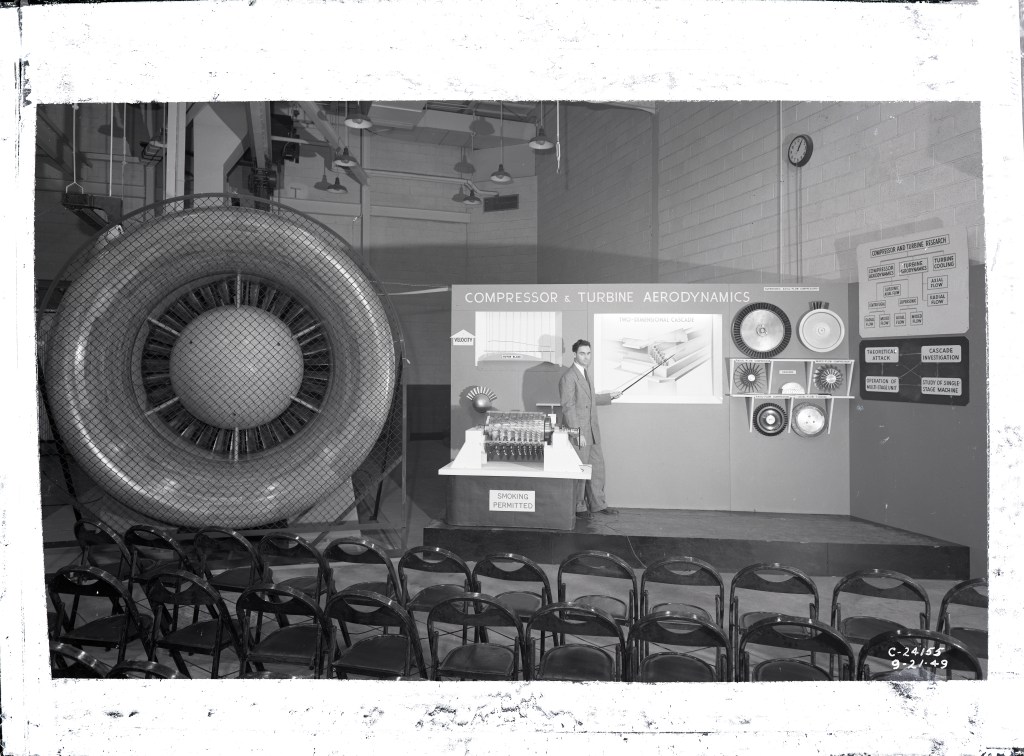 Man with exhibit and large engine