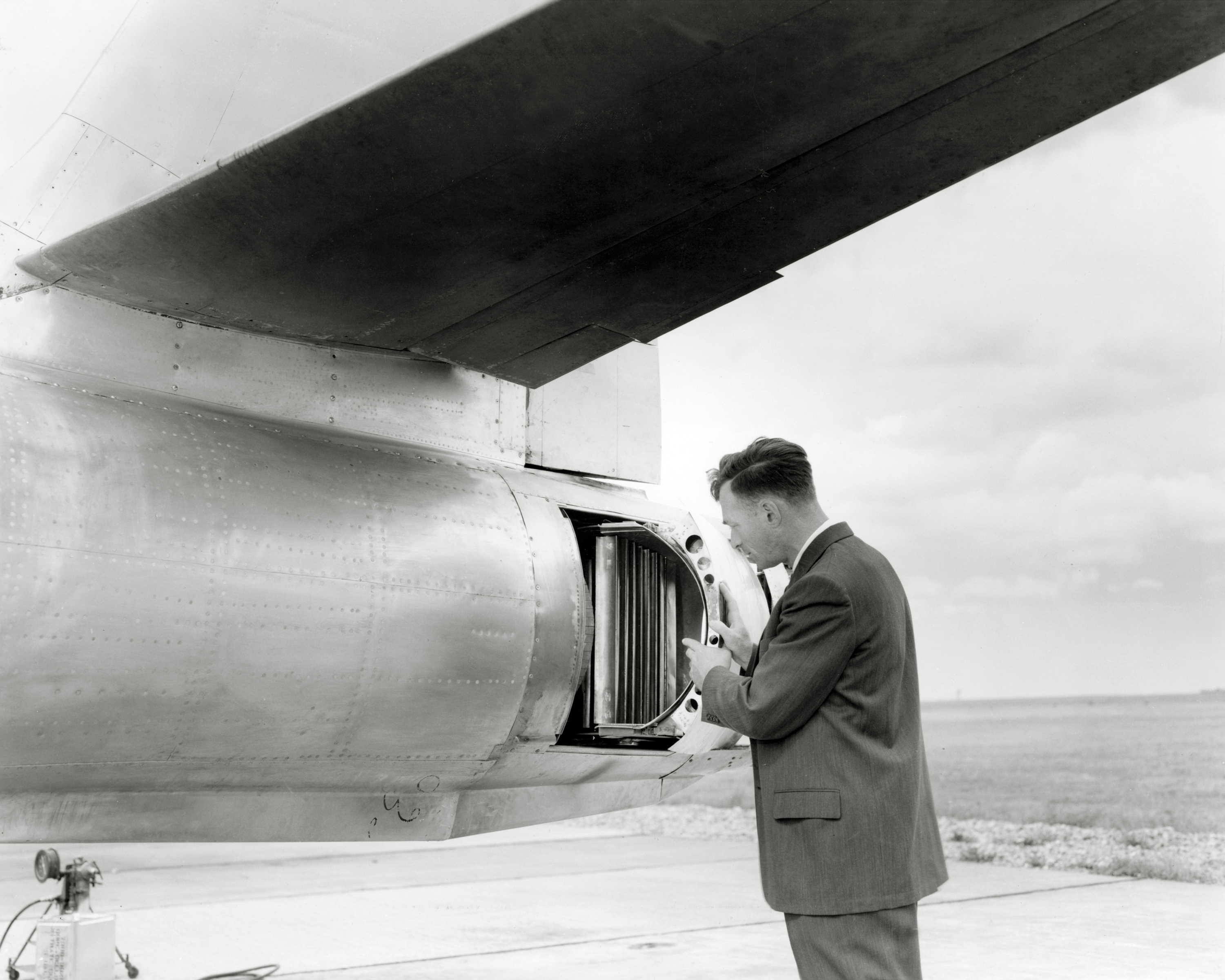 Man looking at aircraft engine.