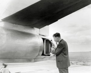 Man looking at aircraft engine.
