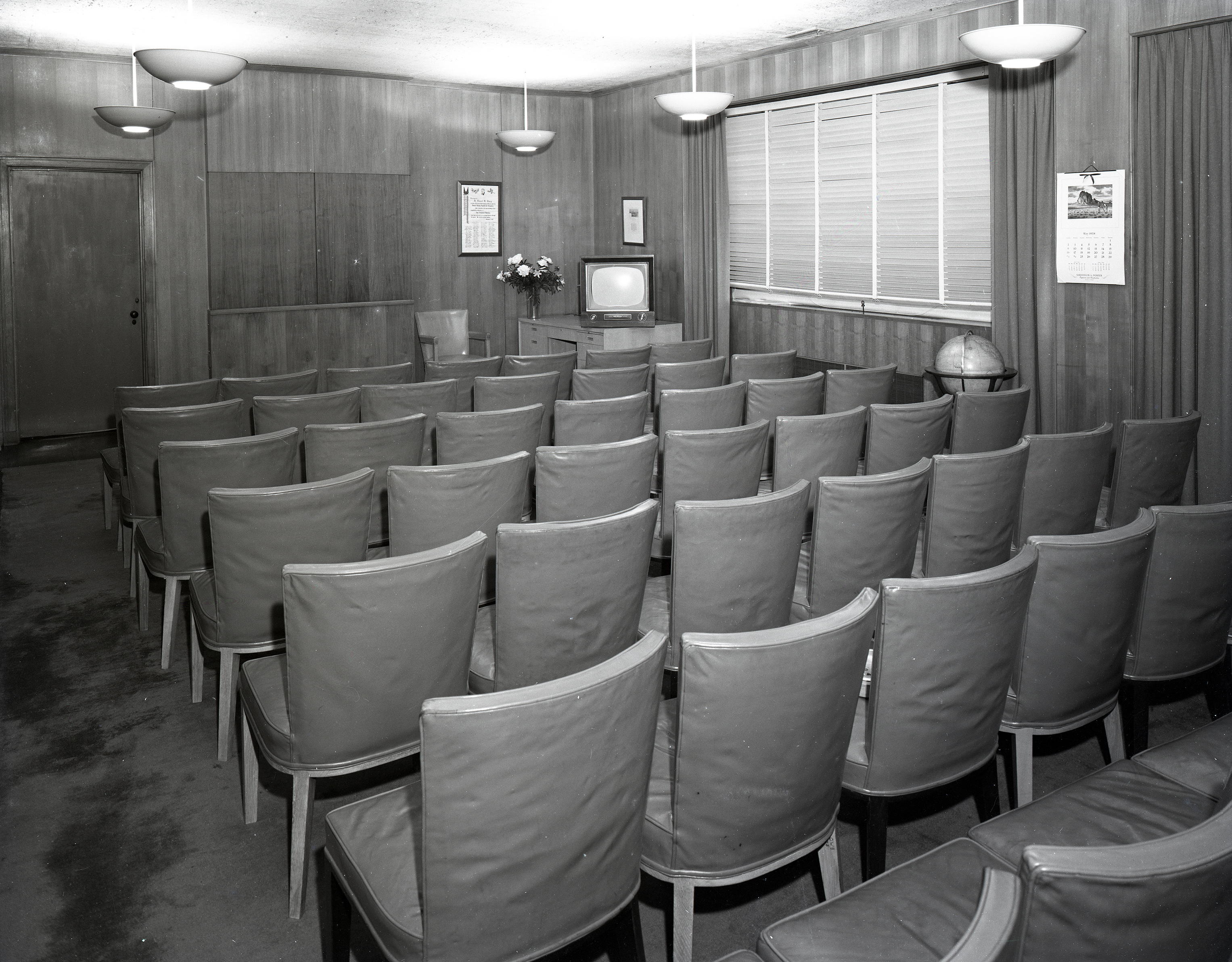 Empty seats in conference room.