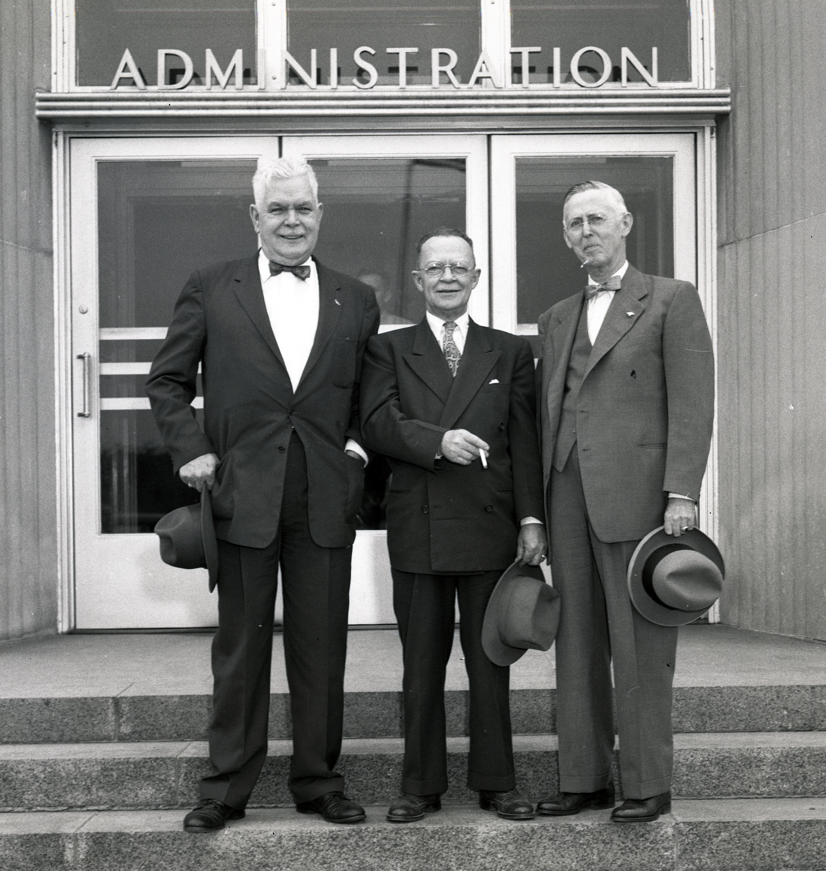Three men standing on steps