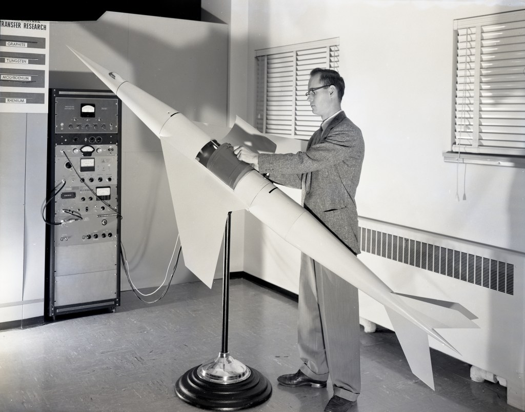 Man with missile model.