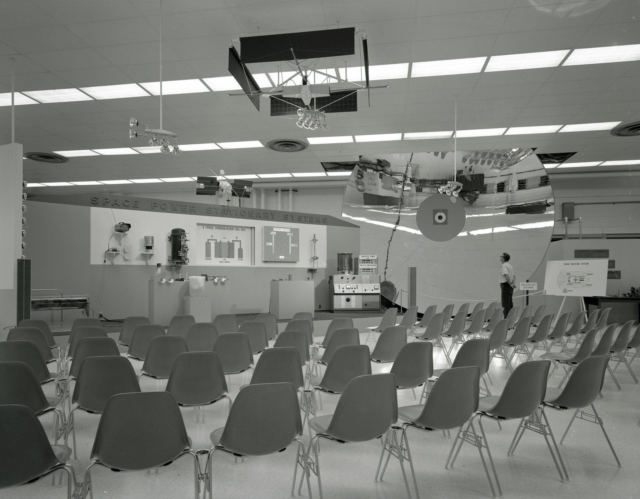 Empty seats in front of exhibit.