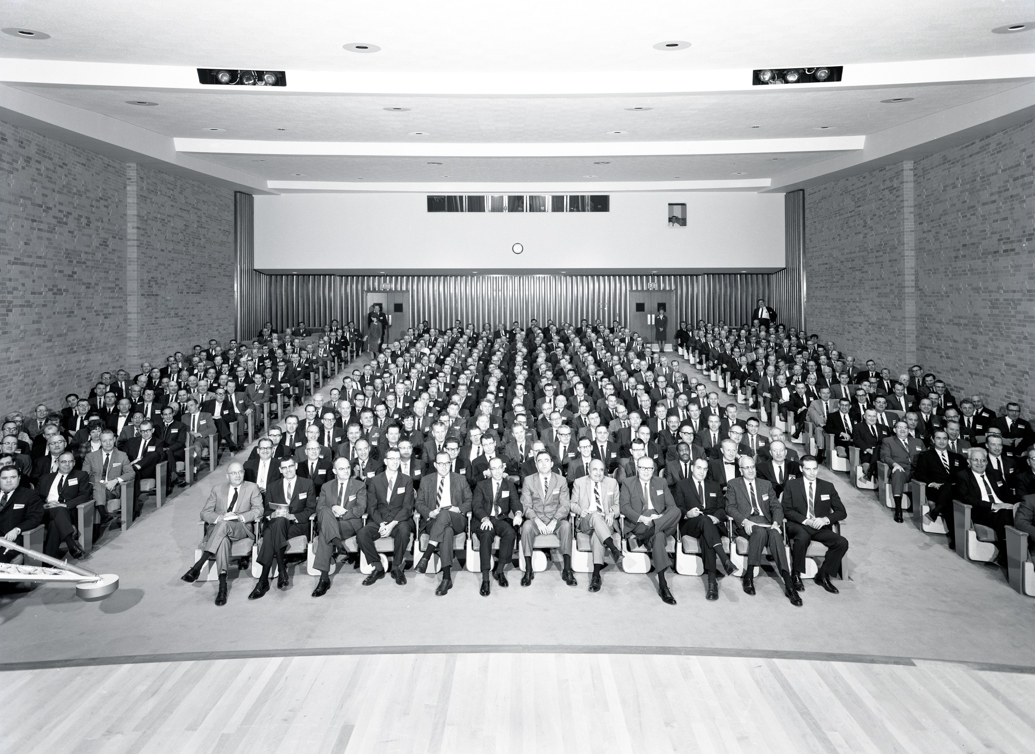 Crowd seated in auditorium.