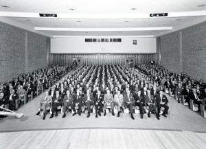 Crowd seated in auditorium.