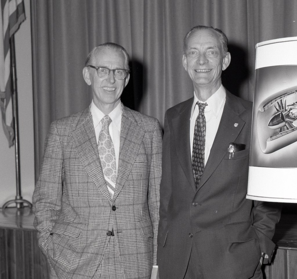 Two men standing.