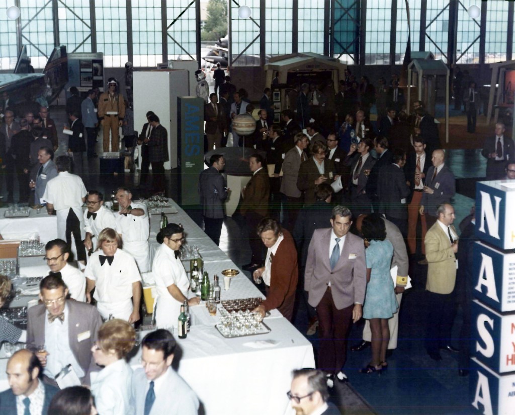 Group mingling in hangar.