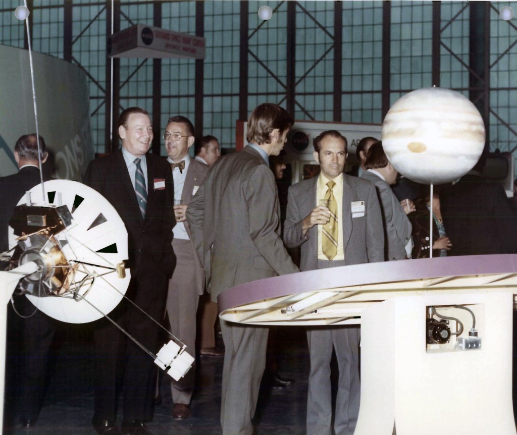 Group mingling in hangar.