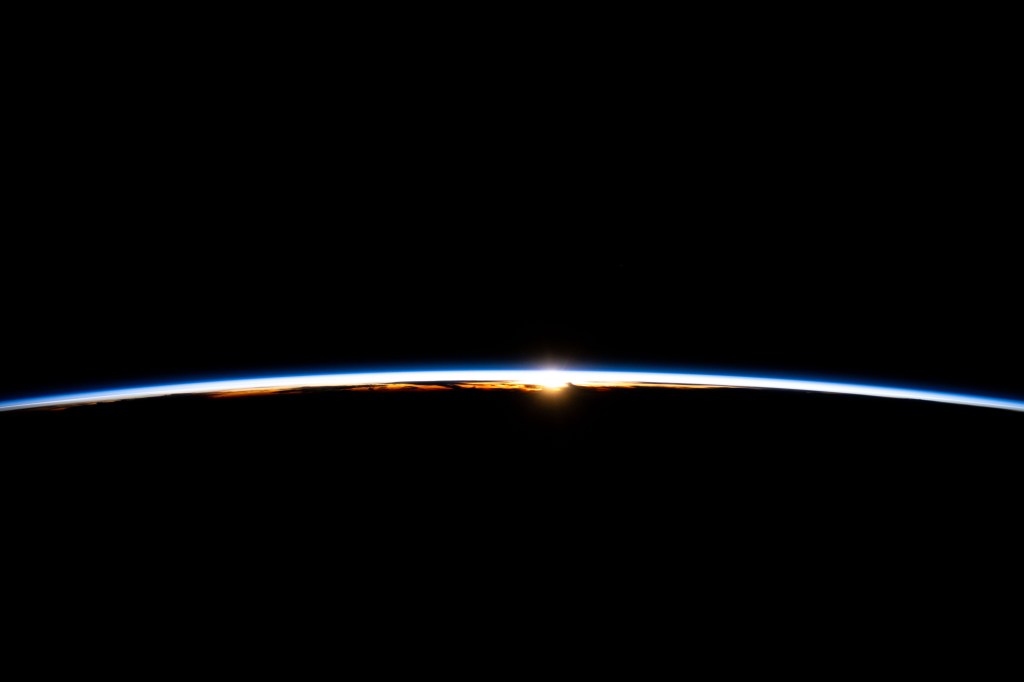 The first rays of an orbital sunrise break through Earth's atmosphere highlighting the cloud tops in this photograph from the International Space Station as it soared 256 miles above the Indian Ocean off the coast of Sumatra, Indonesia.