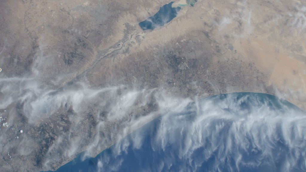 Cirrus clouds cross the Meditteranean coast from Israel and into Jordan in this photograph from the International Space Station as it orbited 262 miles above.