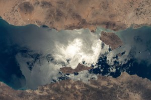 The sun's glint beams off the Gulf of California contrasting Mexico's coastal states of Baja California (bottom) and Sonora (top). In the middle of the frame (clockwise from top) are the islands of Tiburón, Turón, San Lorenzo, and Angel de la Guarda. The International Space Station was orbiting 261 miles above Sonora at the time of this photograph.