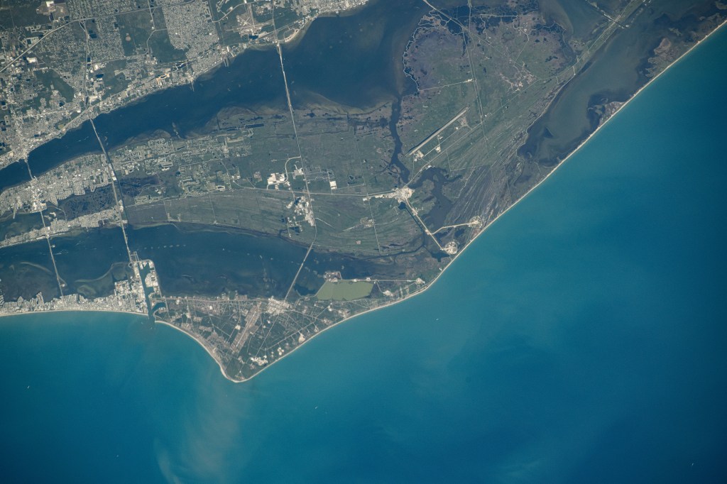 NASA's John F. Kennedy Space Center, the center's Launch Pads 39A and 39B, and the Cape Canaveral Space Force Station on Florida's Atlantic coast are pictured from the International Space Station as it orbited 261 miles above.